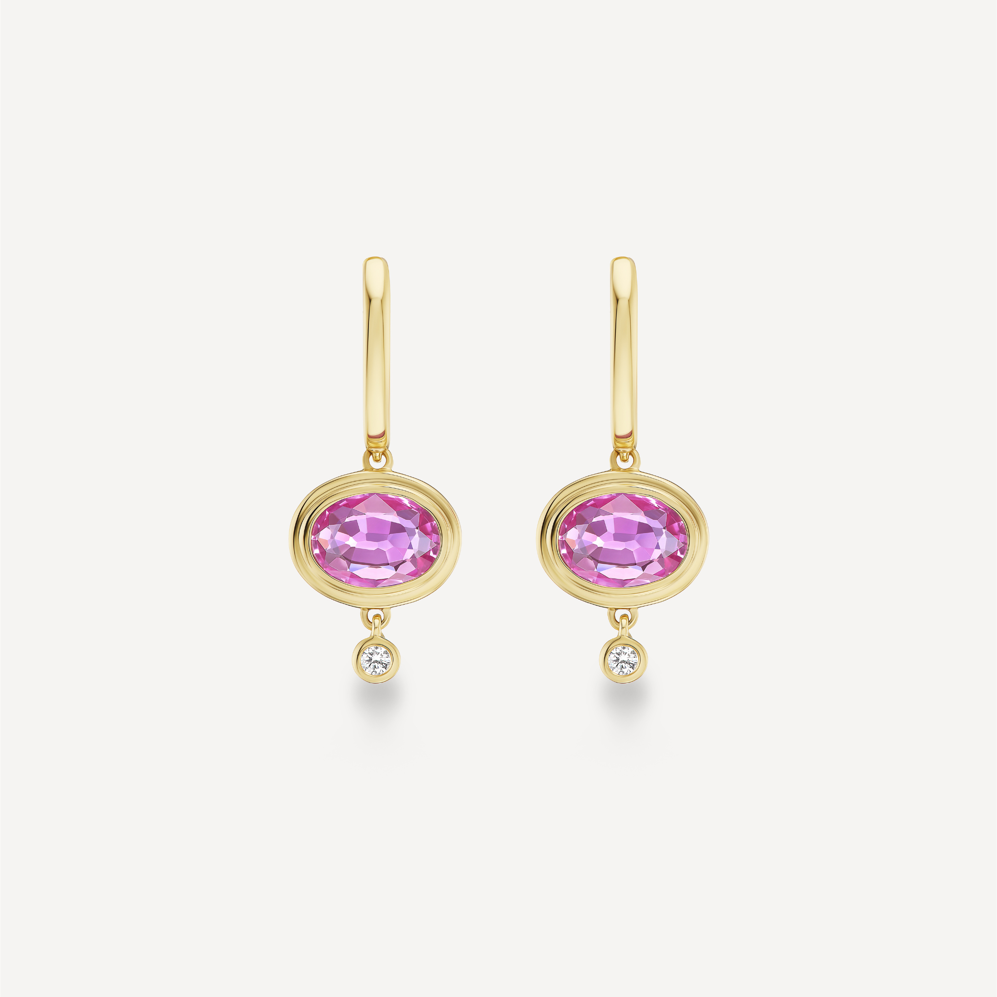 Oval pink sapphire drop earrings in 14K yellow gold with bezel-set diamond drops.